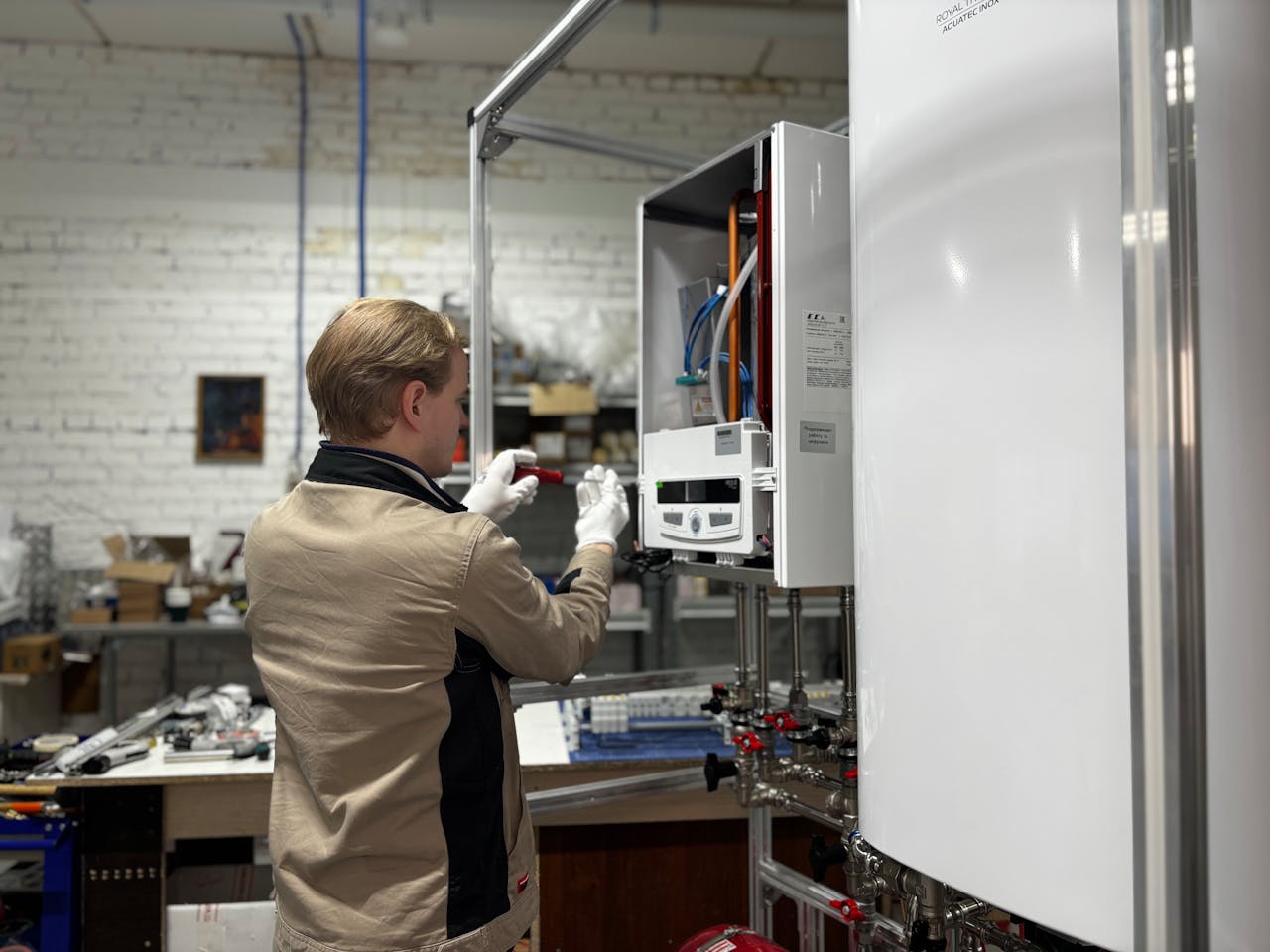 Crafting Captivating Headlines: Your awesome post title goes here Technician inspects and repairs a heating system in an industrial workshop setting.